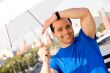 Smiling man holding white umbrella outdoors