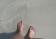 female`s feet in the ocean