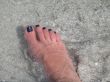 female`s feet in the ocean