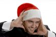 man posing with santa cap and holding his face