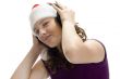 teenager with santa hat and listening to music