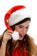 woman with santa cap and looking downward