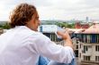 Caucasian man with a cup coffee outdoors