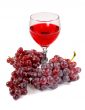 Glass of red wine and grapes clusters