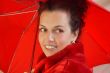 Attractive middleage woman with red umbrella