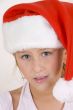 smiling little girl wearing christmas hat