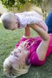 beautiful mother playing with her newborn baby