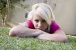 caucasian female lying on the grass