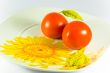 Tomatos on plate with sunflower