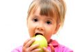 Girl eating green apple