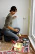 Young woman paints a wall in the kitchen