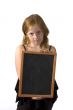 little girl is holding an empty chalkboard