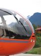orange helicopter with mountain background