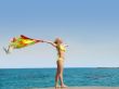 Girl with scarf on a sea beach