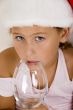little girl with christmas hat and wine glass