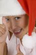 happy little girl wearing christmas hat