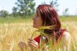Girl resting in meadow with rye ears