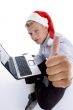 man with christmashat and laptop