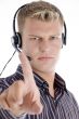 male with headset showing his index finger