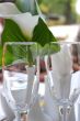 Empty champagne glasses and calla lily flower