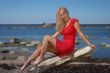 Beautiful woman sitting by the sea