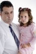father with his daughter and looking to camera