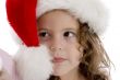 little girl wearing christmas hat