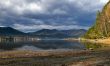 Coastline lake Teletskoe and cloudscape.