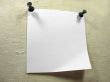 White piece of notice paper over a old canvas background