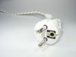 Macro of white two pin plug focused on front