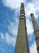 Two chimneys on the cloudy sky