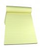 Yellow lined notebook with empty pages isolated over white background