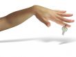Woman hand giving the key isolated over white background