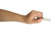 Woman hand giving the key isolated over white background