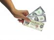 Human lady hand giving cash rare dollars currency isolated over