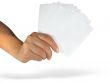 Human lady hand showing empty paper cards isolated over white ba