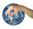 Woman hand giving the key of the world isolated over white
