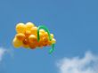 Sheaf of balloons in the form of grapes cluster against the blue sky