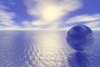 abstract glass globe over blue ocean and sunset cloudy sky