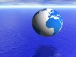 planet earth globe over blue ocean and cloudy sky
