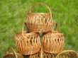three wicker wooden baskets over green grass background
