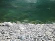 grey rock and green river