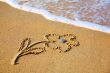 `Flower` drawing at sand, with sea wave