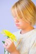 Blond Woman with a Bright Yellow Flower