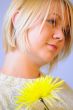 Blond Woman with a Bright Yellow Flower