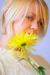 Blond Woman with a Bright Yellow Flower