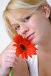 Blond woman with an Orange Flower