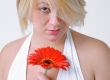 Blond woman with an Orange Flower