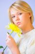 Blond Woman with a Bright Yellow Flower