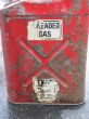 an old and rusty red gas can